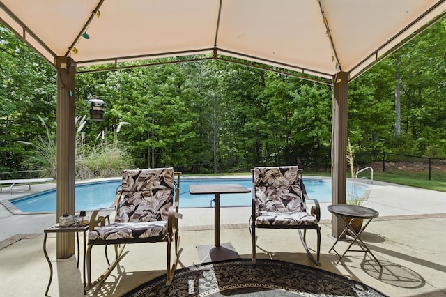 outdoor pool featuring a gazebo and fence