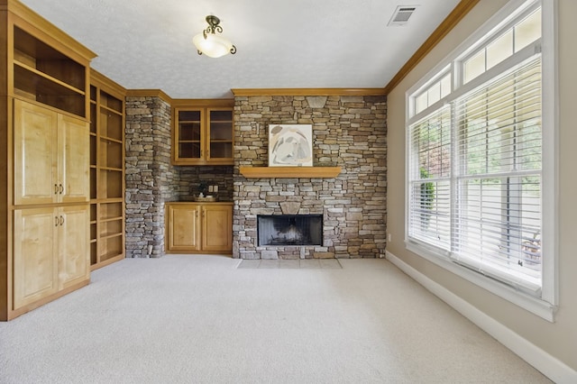 unfurnished living room featuring carpet floors, baseboards, ornamental molding, and visible vents