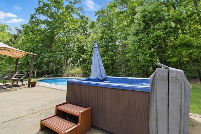 pool with a hot tub, a diving board, and a patio