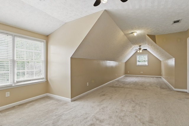 bonus room featuring vaulted ceiling, visible vents, and a ceiling fan