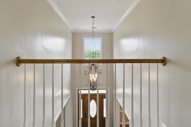 room details featuring an inviting chandelier, crown molding, a textured ceiling, and visible vents