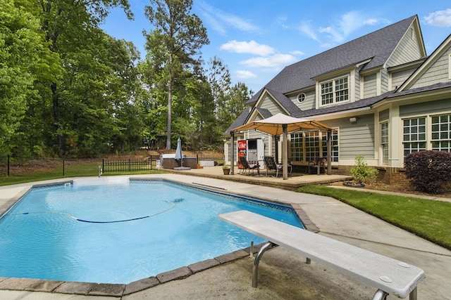 view of swimming pool with a fenced in pool, fence, a diving board, a patio, and a gazebo