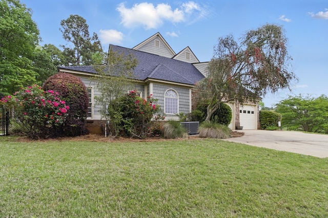 view of front of property with a garage, driveway, a shingled roof, and a front lawn