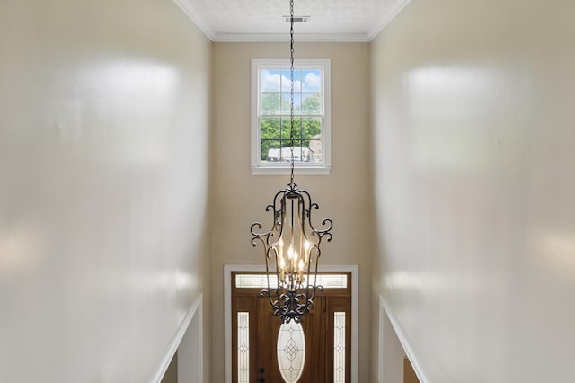 details with a chandelier, a textured ceiling, visible vents, and crown molding