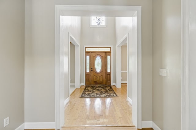 foyer with baseboards and wood finished floors