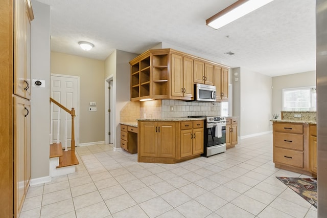 kitchen featuring open shelves, light tile patterned flooring, appliances with stainless steel finishes, and tasteful backsplash