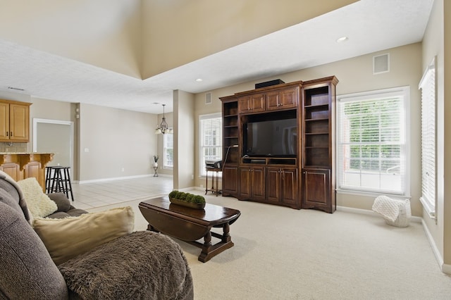 living area featuring visible vents, baseboards, and recessed lighting