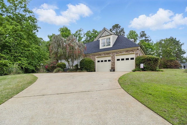 view of front of property with driveway, a garage, a shingled roof, and a front yard