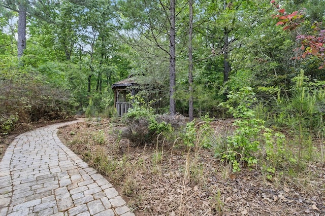 view of yard with a forest view and a gazebo