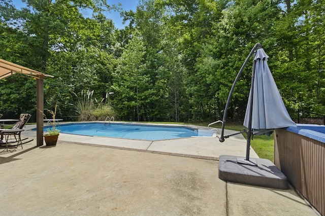 outdoor pool with a patio area and a diving board