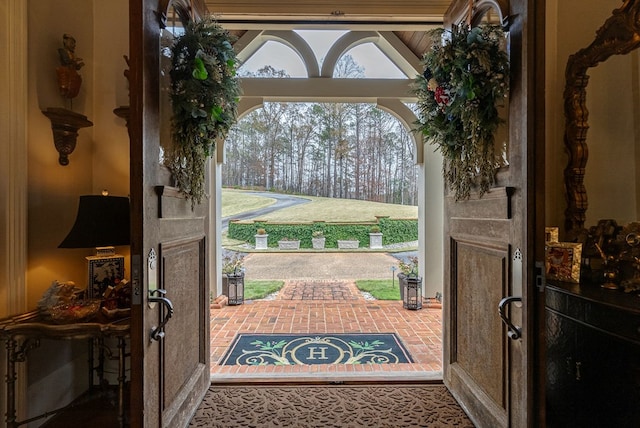 entryway featuring vaulted ceiling with beams