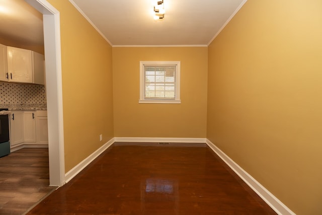 unfurnished dining area with dark hardwood / wood-style flooring and ornamental molding