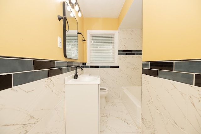 bathroom with a bathing tub, vanity, tile walls, and toilet