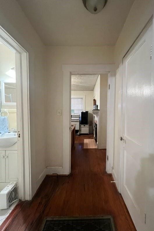 corridor with sink and dark hardwood / wood-style floors