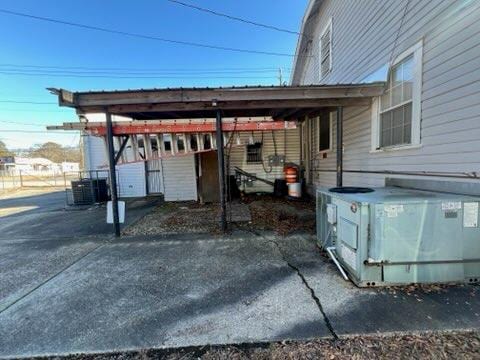 exterior space featuring a carport and cooling unit