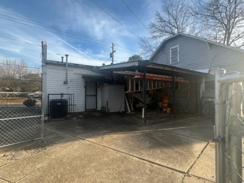 view of side of property with a carport and cooling unit