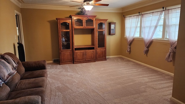 living room with crown molding, ceiling fan, and light carpet