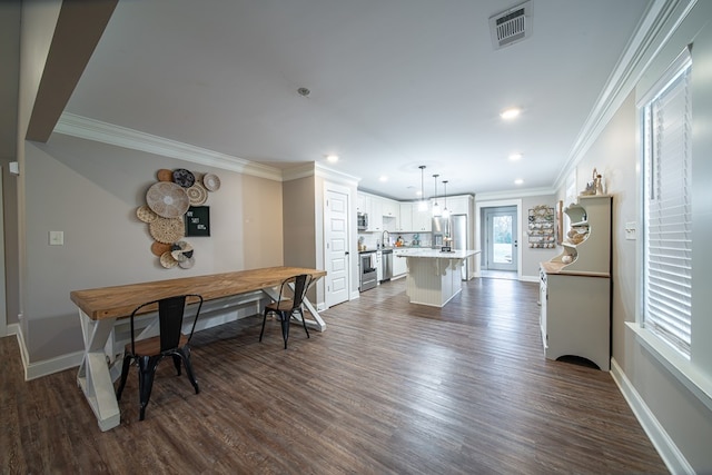 dining space with ornamental molding and dark hardwood / wood-style flooring