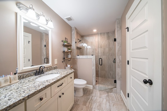 bathroom with vanity, toilet, and walk in shower