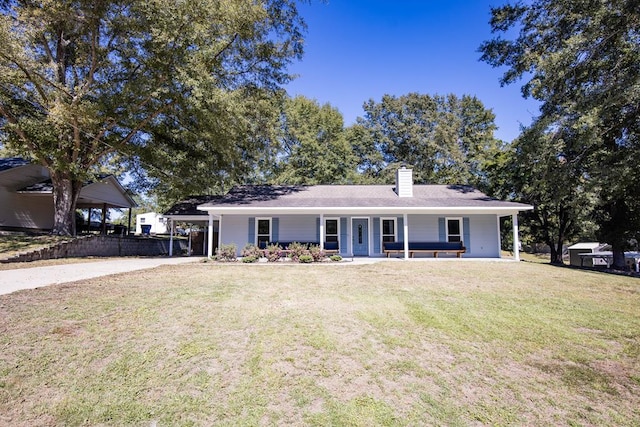 ranch-style home with a carport, a porch, and a front lawn