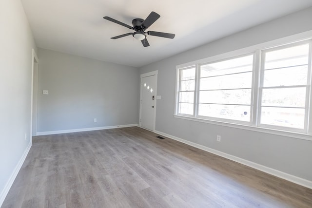 spare room with ceiling fan and light hardwood / wood-style floors