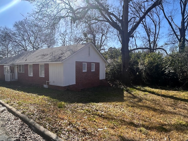 view of side of home featuring a yard