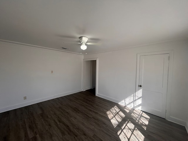 spare room with crown molding, ceiling fan, and dark hardwood / wood-style flooring