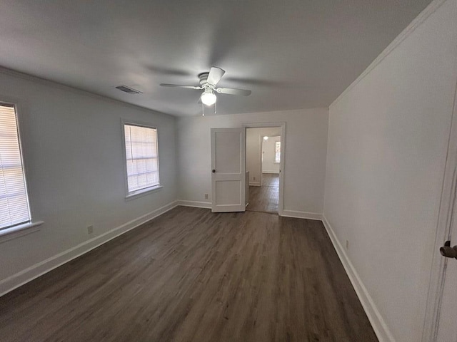 spare room featuring ceiling fan, ornamental molding, and dark hardwood / wood-style floors