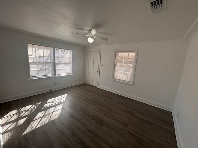 unfurnished room with dark wood-type flooring, plenty of natural light, ornamental molding, and ceiling fan