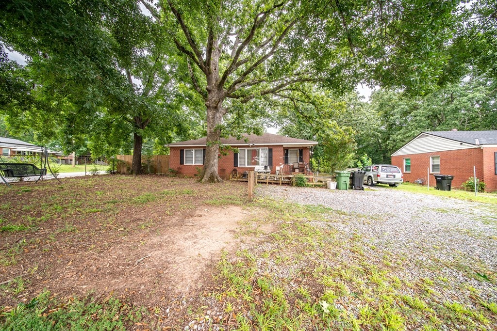 532 48th St, Columbus, GA 31904 - ranch-style house with brick siding and view of wooded area