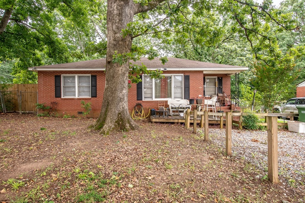 532 48th St, Columbus, GA 31904 - view of front facade featuring brick siding, a deck, and roof with shingles