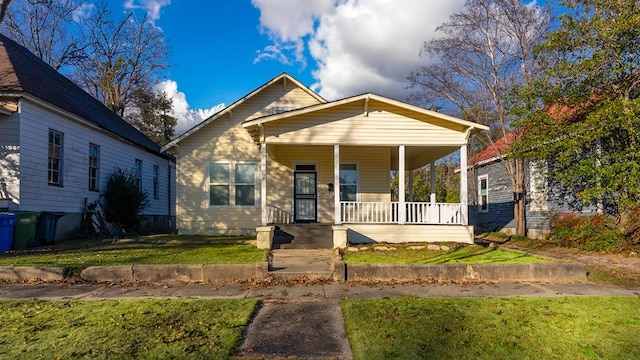 bungalow-style home with a porch and a front yard