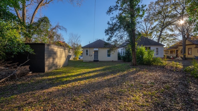 rear view of property featuring a yard