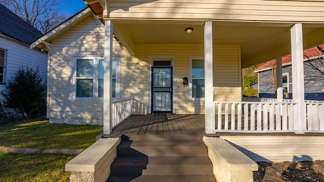 view of exterior entry with a porch