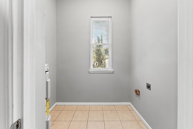 clothes washing area featuring hookup for an electric dryer and light tile patterned floors