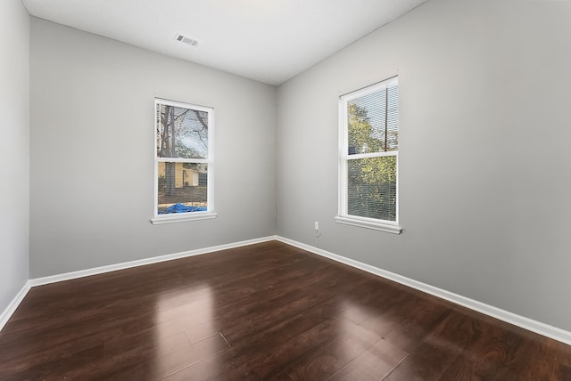 unfurnished room with hardwood / wood-style flooring