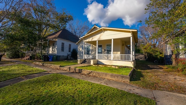 bungalow-style house with covered porch and a front yard