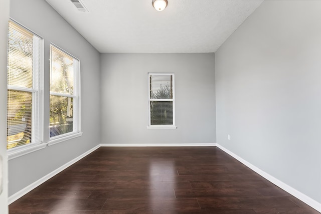 spare room featuring dark hardwood / wood-style flooring