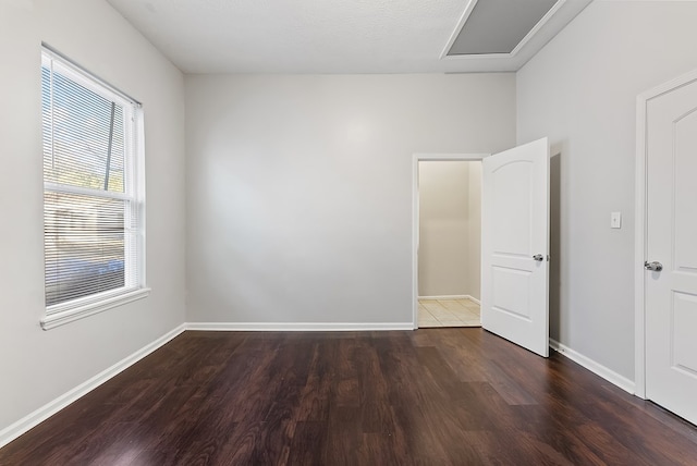 spare room featuring dark hardwood / wood-style flooring