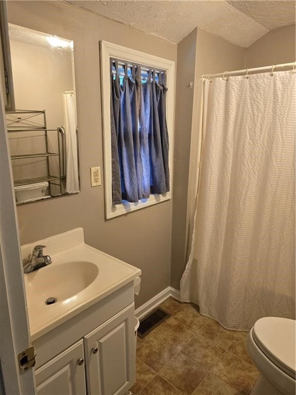 1009 11th St, Phenix City, AL 36867 - bathroom featuring a textured ceiling, vanity, and a shower with curtain