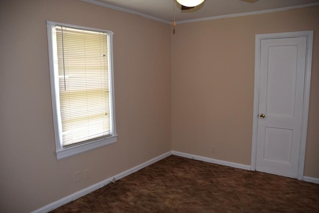 unfurnished room with dark colored carpet, ceiling fan, and ornamental molding