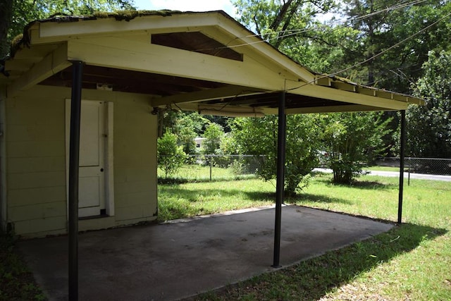 view of car parking with a yard and a carport