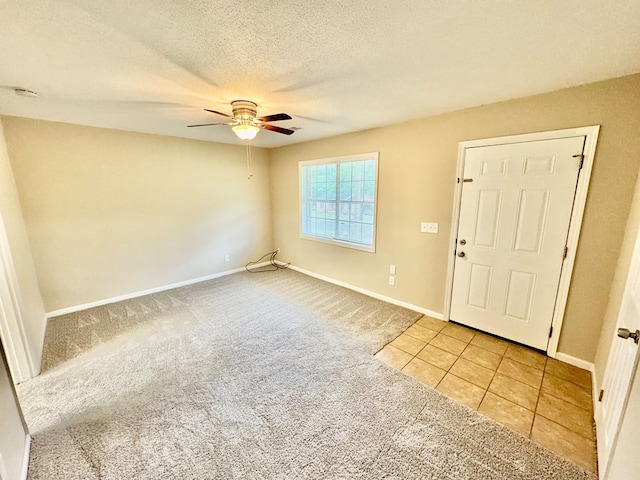 644 Parkwood Dr, Columbus, GA 31907 - carpeted entrance foyer featuring a ceiling fan, baseboards, tile patterned flooring, and a textured ceiling