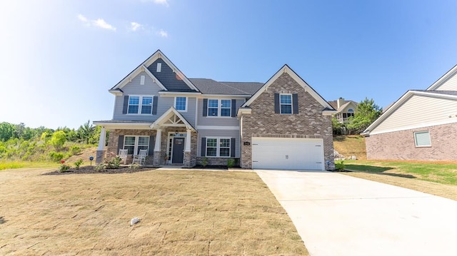 craftsman-style house featuring a front lawn and a garage