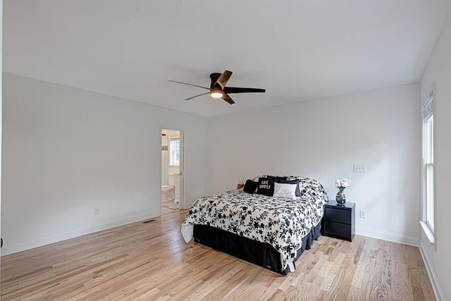 bedroom featuring ensuite bath, light hardwood / wood-style floors, and ceiling fan