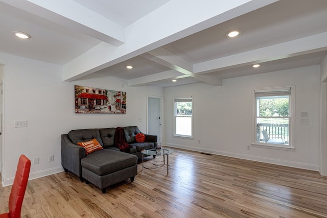 living room with beamed ceiling and light hardwood / wood-style floors