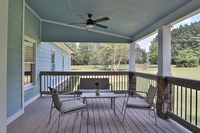 wooden deck featuring a yard and ceiling fan