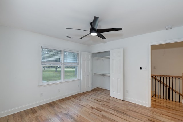 unfurnished bedroom featuring light hardwood / wood-style floors, a closet, and ceiling fan