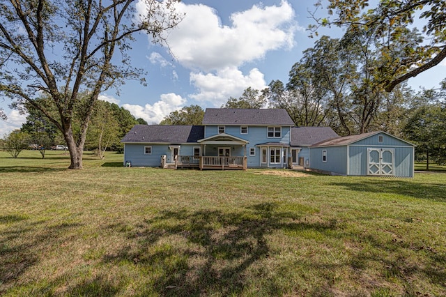 back of house featuring a storage shed, a yard, and a deck