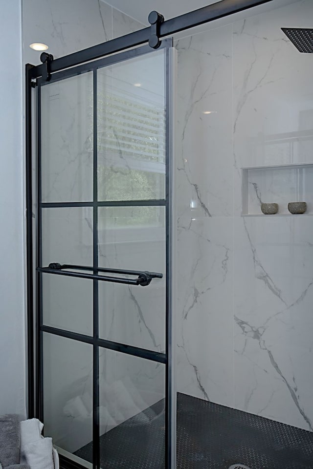 bathroom with tiled shower